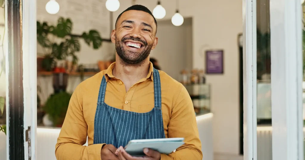 a man welcoming a customer into a restaurant