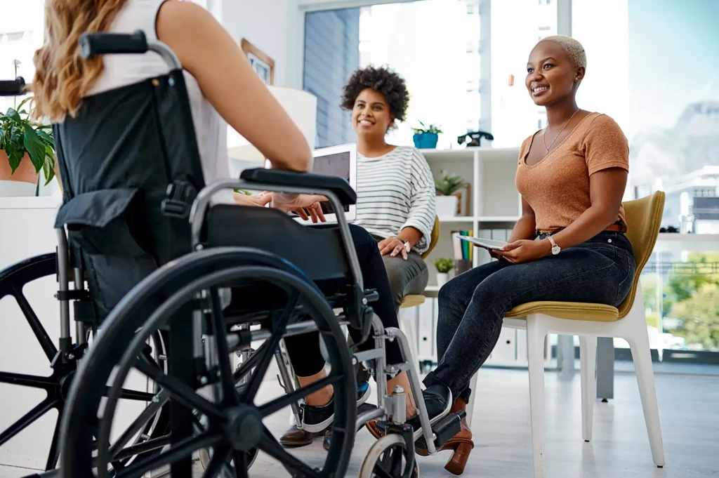 Wheelchair user in an office with collegues