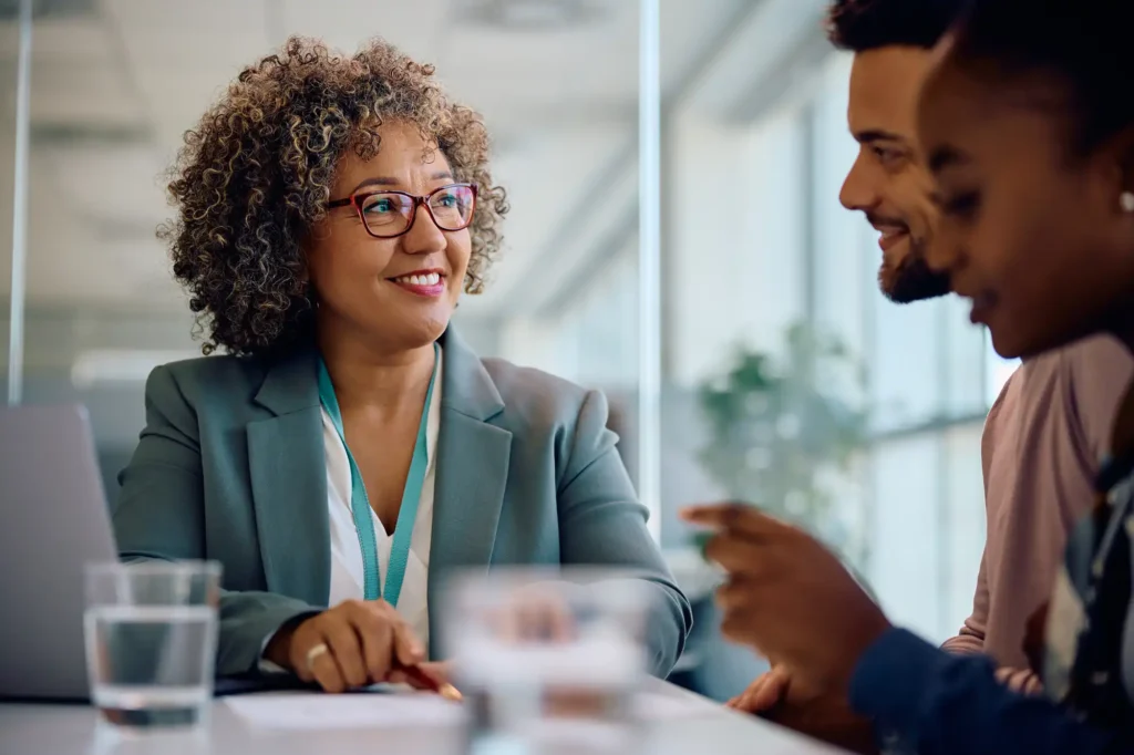 Real estate agent with clients talking about a property