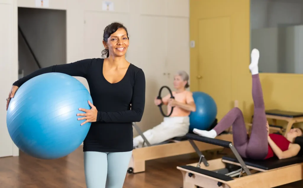 A pilates instructor in a studio