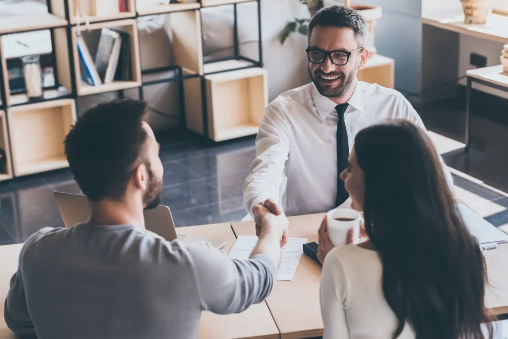 Real estate agent with clients talking about a property
