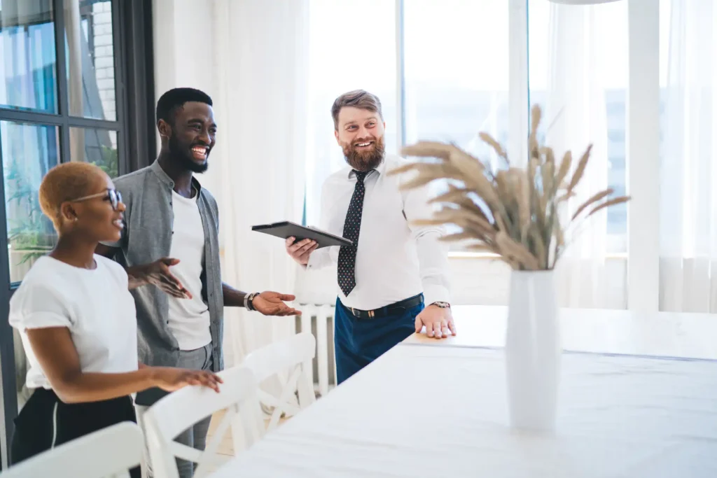 Real estate agent with clients talking about a property