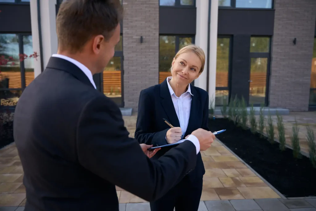 Real estate agent with clients talking about a property