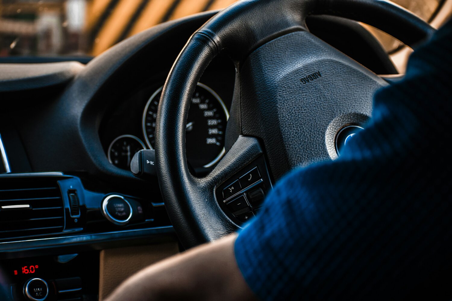 Mick is shown at the steering wheel of his car
